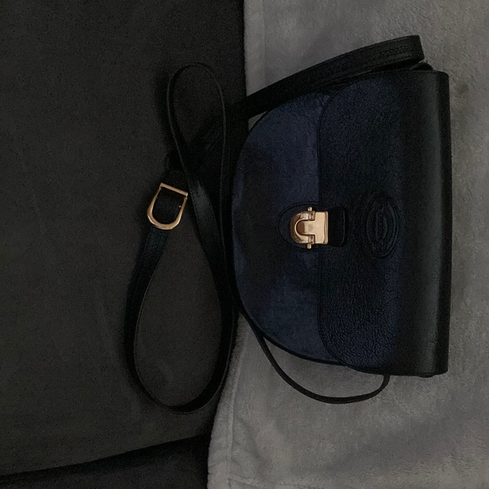 Black OROTON designer handbag. May be worn crossbody.